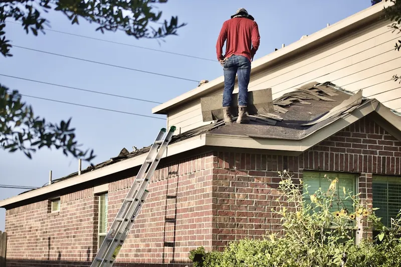 Professional roofer working on a residential roof in Fries Mill